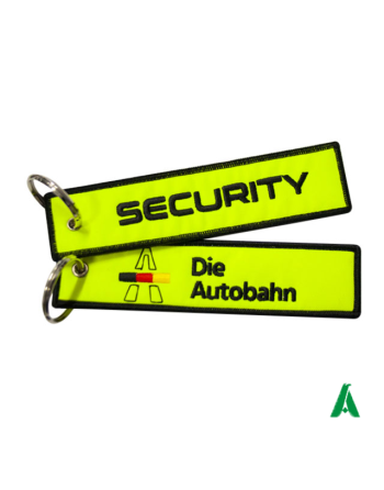 Yellow fluorescent keychains on resistant fabric nylon poliester for security and as a promotional gadget for corporates.