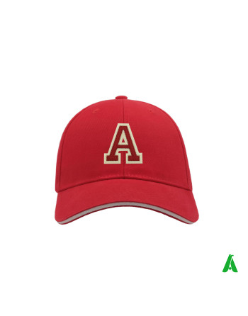 Red cap with a peak, personalised with the letter ‘A’ embroidered on a double layer of red and ecru felt