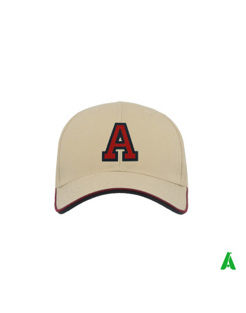 A beige summer cotton twill hat that can be personalised with an embroidered and sewn-on felt letter ‘A’.